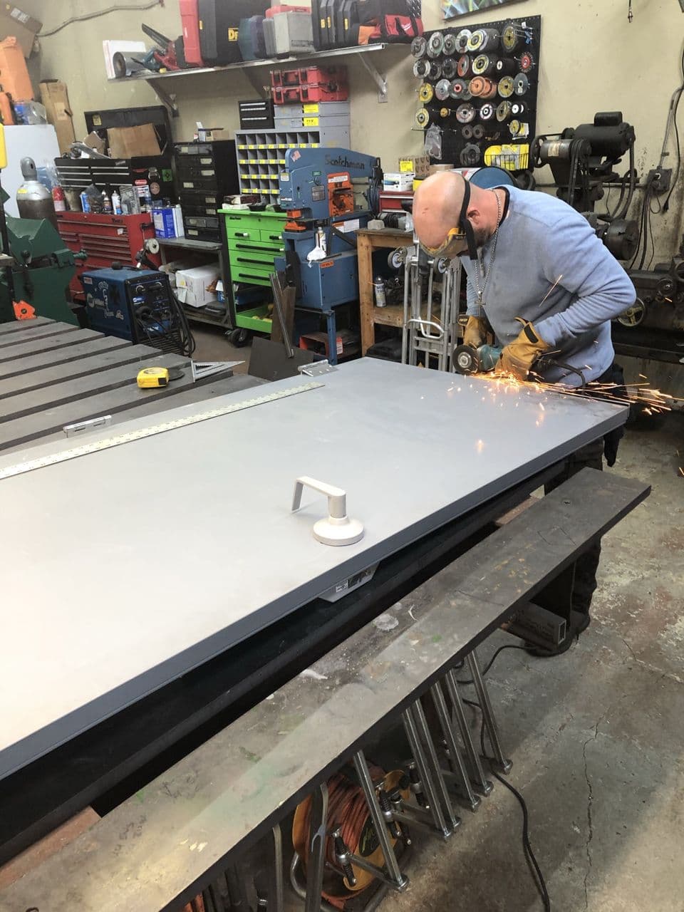 Structural steel pipe grinding in progress shop — Naples Welding Inc., Naples FL